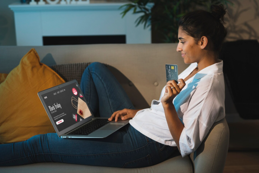 Woman comparing ad-supported streaming plans and ad-free options on a laptop.