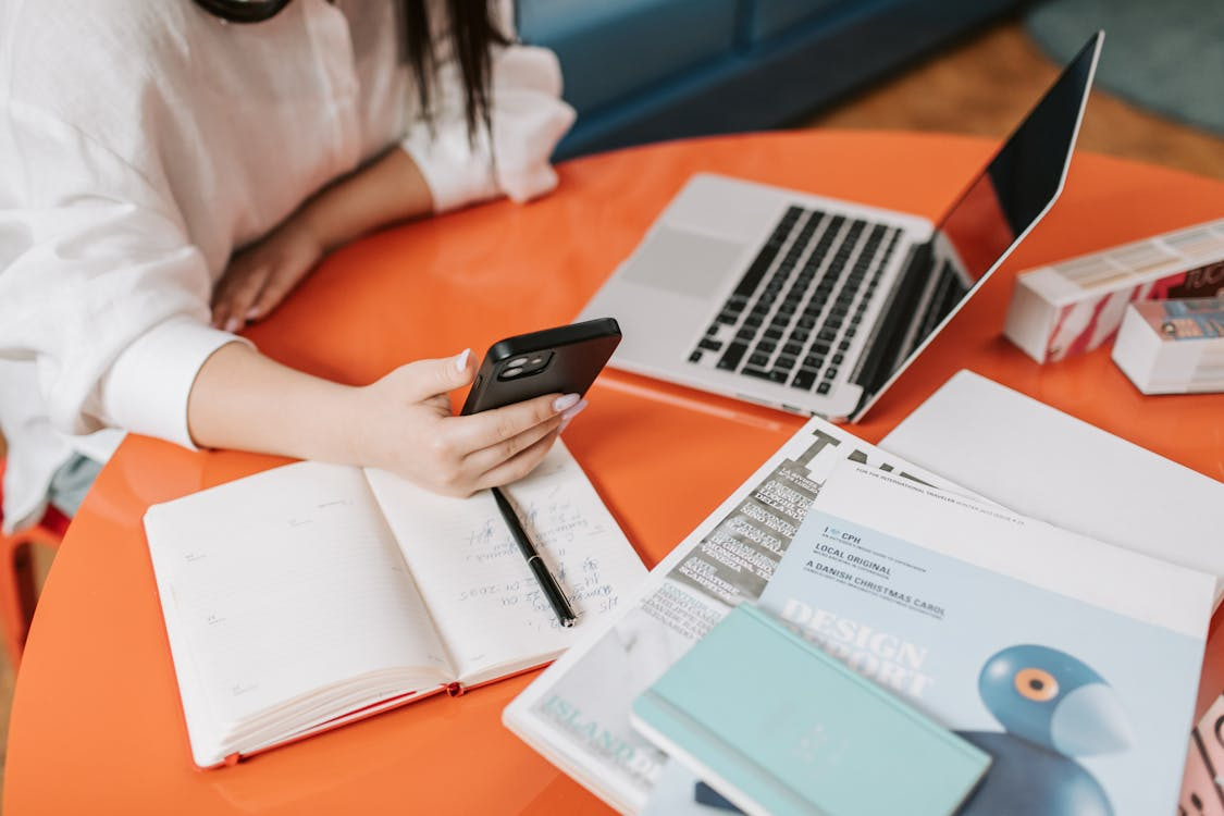 Person reviewing bills while comparing the cheapest cell phone plans with good data speeds.