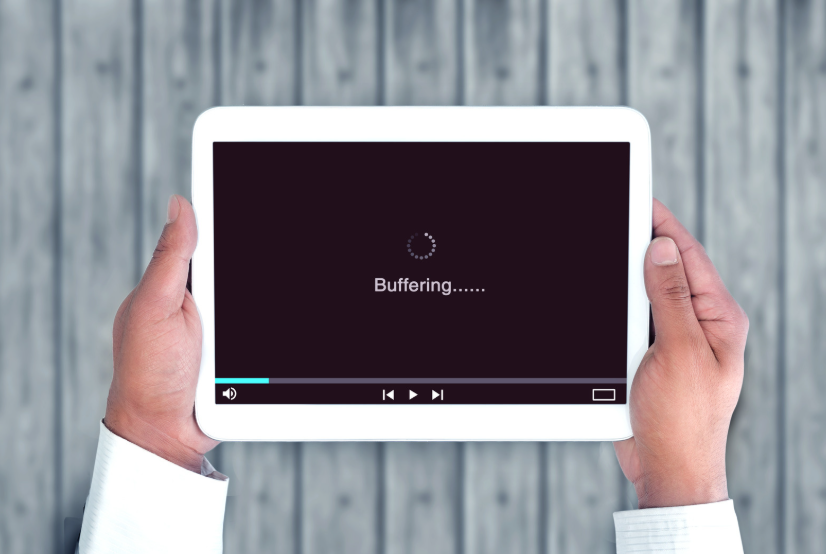 Internet data caps causing buffering on a tablet while streaming video online.