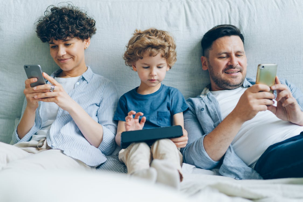 Family using multiple devices at home while comparing the best internet plans for streaming without buffering.