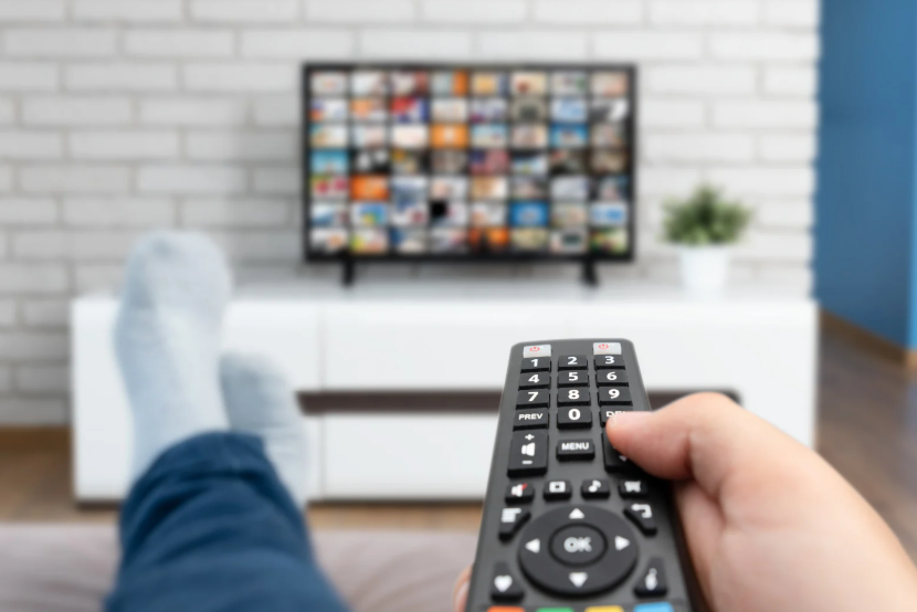 Netflix vs Hulu vs Disney Plus comparison shown through a smart TV streaming menu and remote.